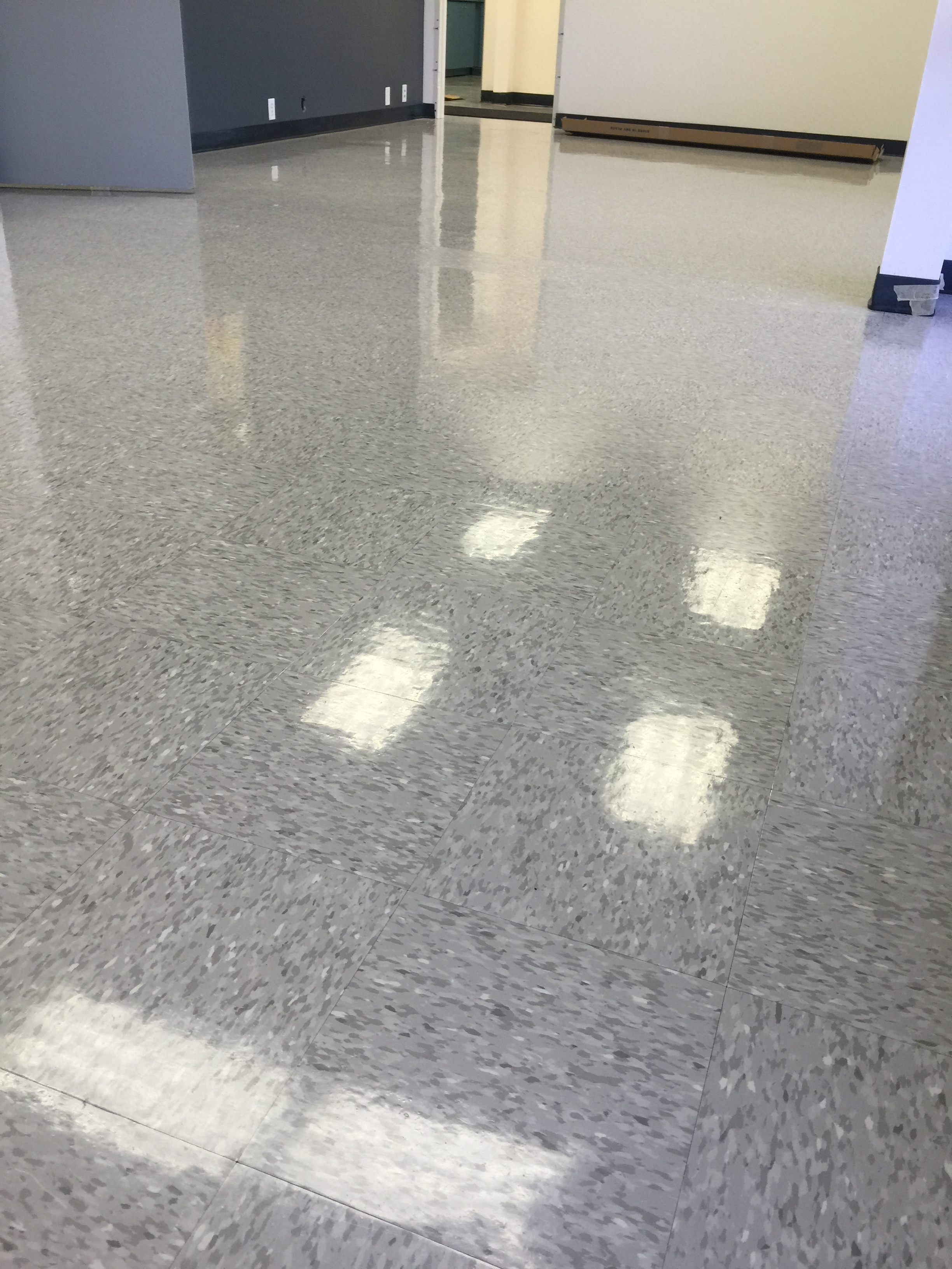 Buffed VCT floor with a high-gloss finish in a commercial office.