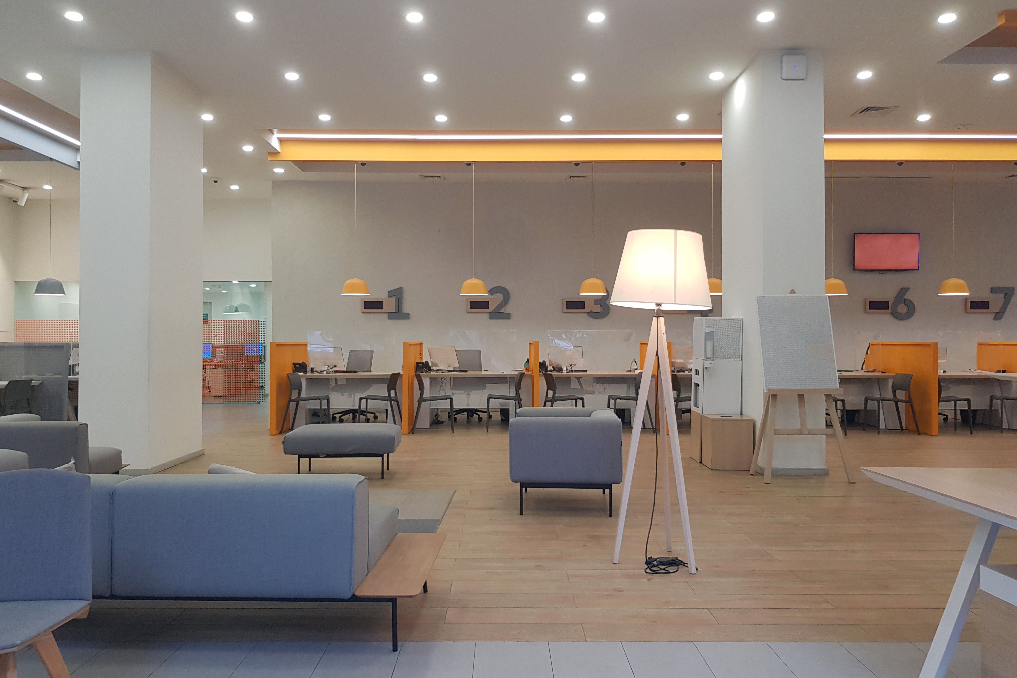 bank with numbered teller stations, bright and modern.