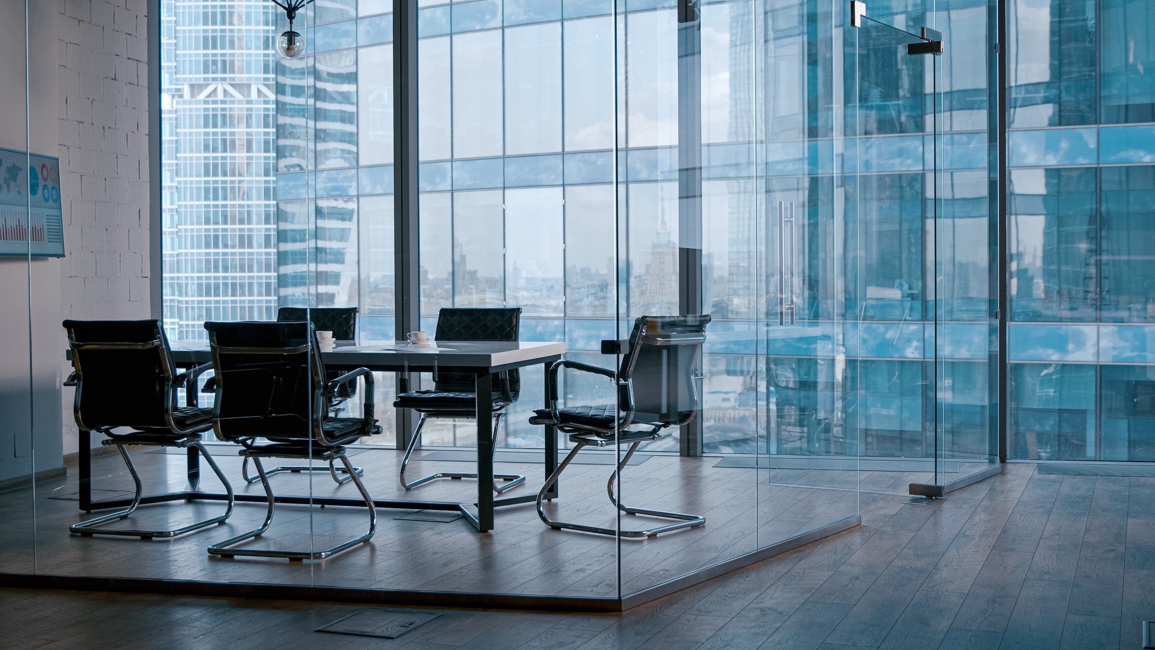 Modern corporate conference room with city views through floor-to-ceiling windows