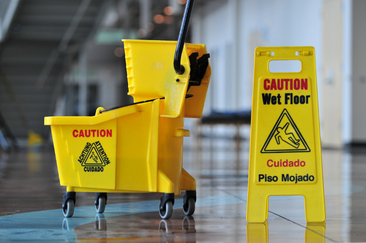 Mop bucket and caution sign